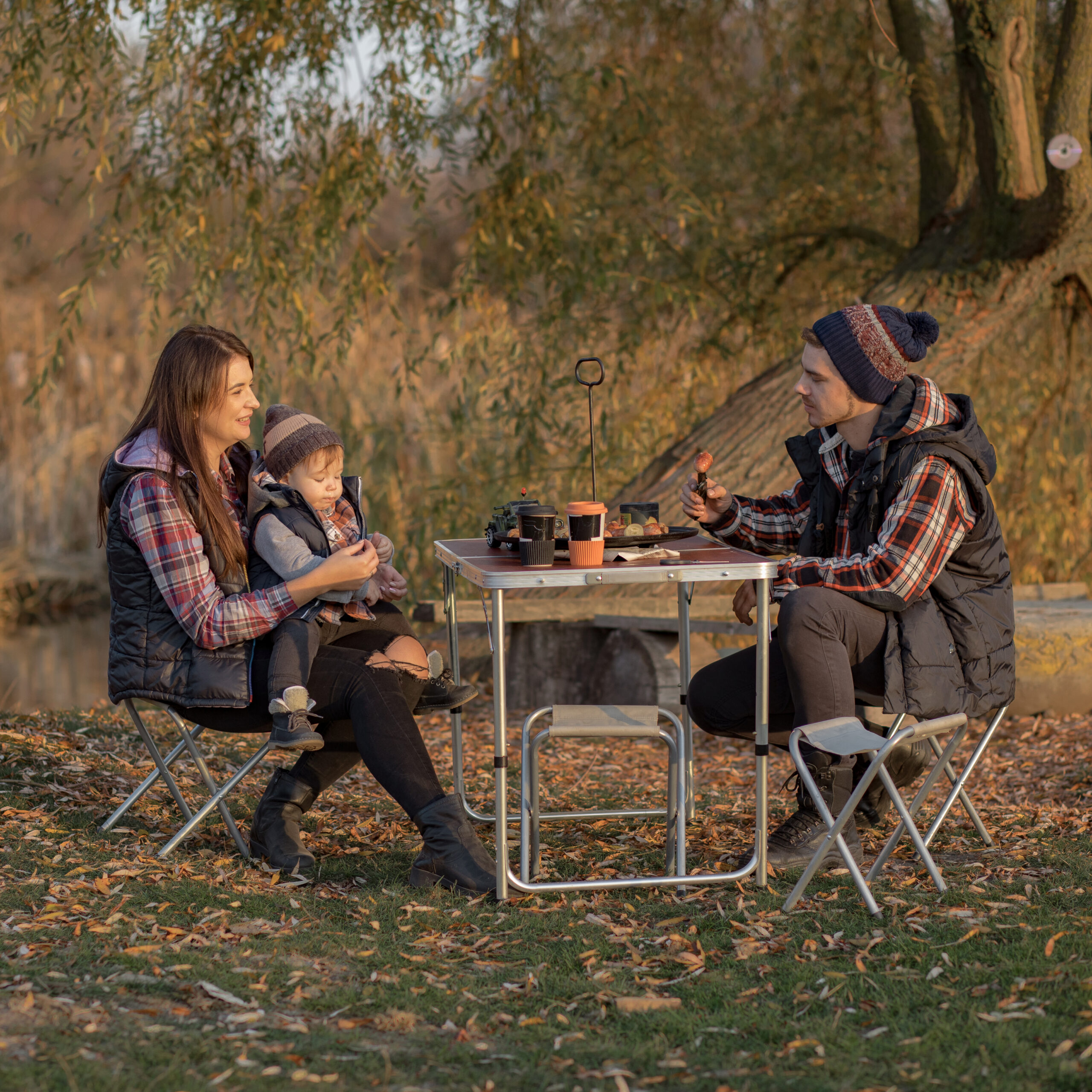 Family with cute little son. Man with son eatting meat. People on a picnick. Family with cute little son. Man with son eatting meat. People on a picnick.